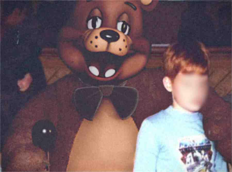 Photograph of the Freddy walkaround costume, along with an unknown child